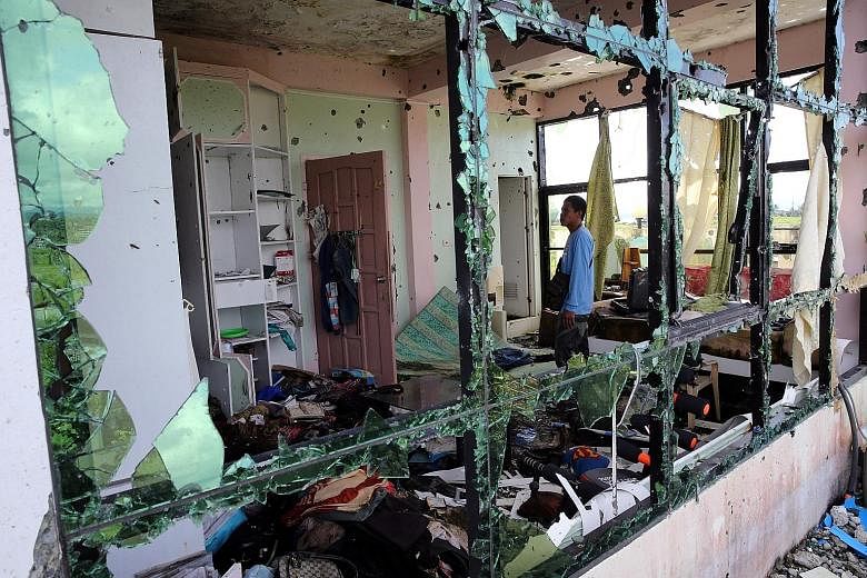 A member of Marawi's security forces inspecting a damaged room in Isnilon Hapilon's hideout. The terrorist's death in a military operation on Oct 16 was the catalyst for the end of the Philippines' longest and most intense urban battle in recent hist