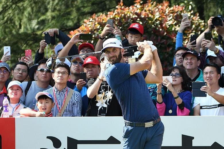 Dustin Johnson teeing off during the third round of the WGC-HSBC Champions yesterday. By the end of the day, he was closer to winning his third WGC title of the year.