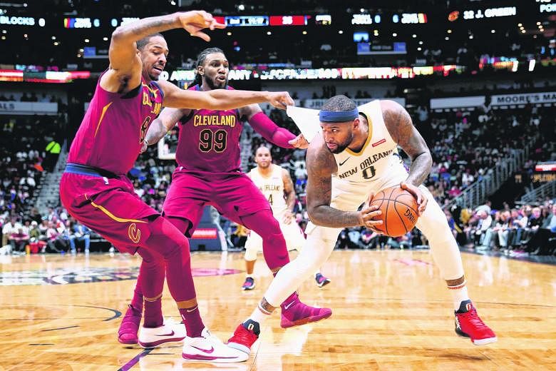 New Orleans Pelicans forward DeMarcus Cousins shielding the ball from Cleveland Cavaliers forwards Channing Frye (No. 8) and Jae Crowder. They have been also-rans the past two seasons, but with Cousins and Anthony Davis in form and finally clicking a