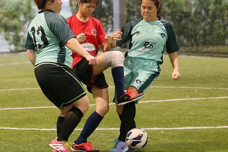 From left in green: Touch Silent Strikers C's Tina Li and Lim Jia Yi tackling Ninja Turtles' Neoh Yew Kim (in red) in the women's futsal final at the third National Deaf Games yesterday. Touch won 2-0. The futsal tournament marked the first of four s