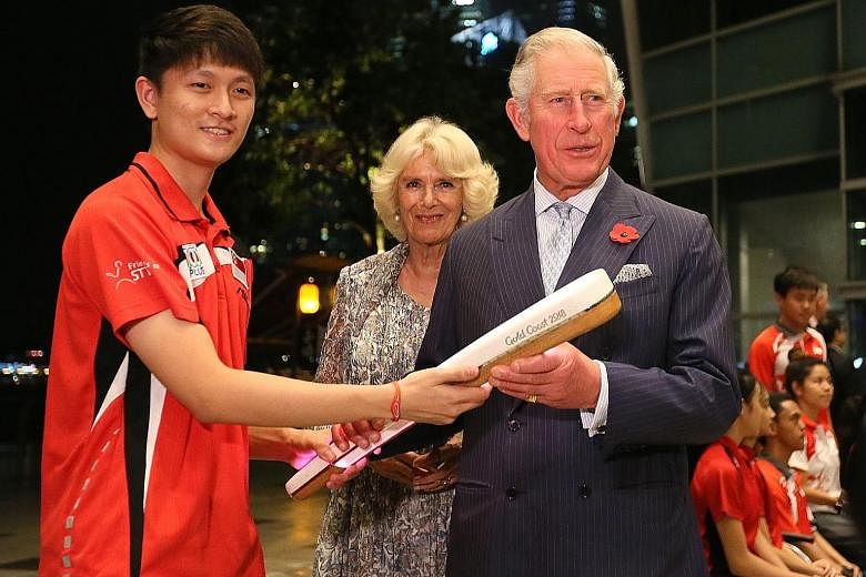 Britain's Prince Charles received the Commonwealth Baton from national table tennis player Clarence Chew, 21, last night, while his wife Camilla, the Duchess of Cornwall, looked on. The royal couple, who are here on an official visit, met Mr Chew, a 