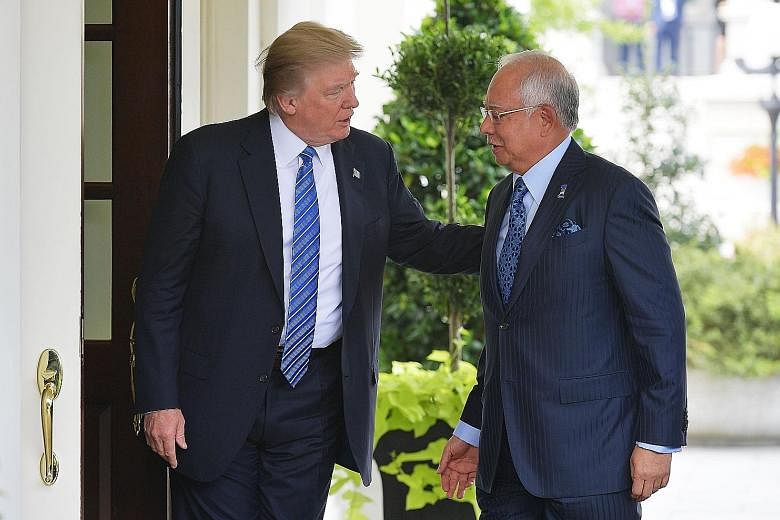 President Donald Trump greeting Prime Minister Najib Razak outside the West Wing of the White House on Sept 12. The Malaysian opposition allege that Mr Trump did not want to meet Datuk Seri Najib due to the ongoing US probe into state fund 1Malaysia 