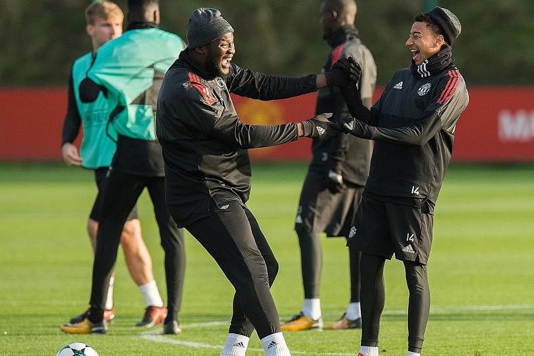 Manchester United's Romelu Lukaku and Jesse Lingard are all smiles in training ahead of today's home tie against Benfica. The Belgian striker will be hoping to end a three-game run without a goal against the rock-bottom Portuguese side at Old Traffor