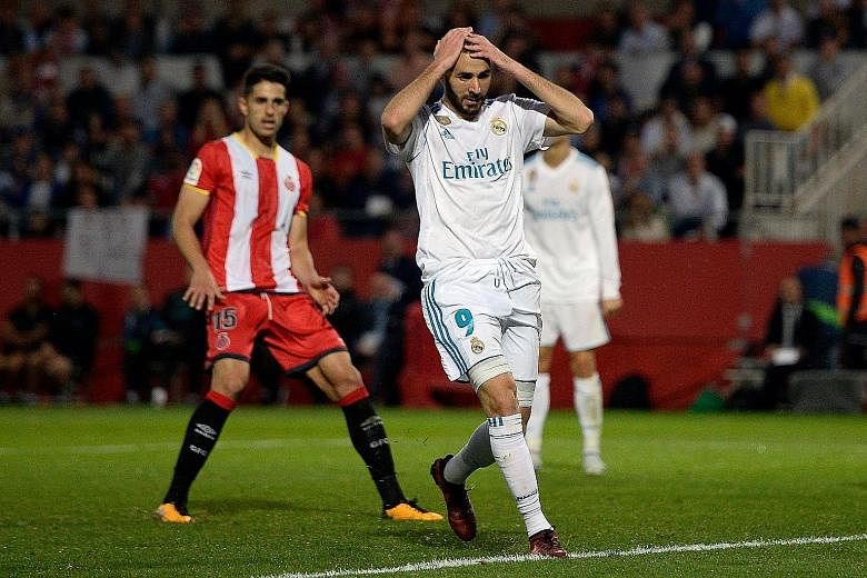 Real Madrid's Karim Benzema castigating himself after missing a chance during their 1-2 loss to Girona. To compound matters, Raphael Varane may miss Wednesday's Champions League tie at Spurs, having suffered an injury during the away defeat.