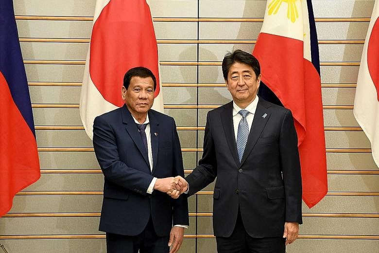Philippine President Rodrigo Duterte meeting Japanese Prime Minister Shinzo Abe before talks at Mr Abe's official residence in Tokyo yesterday. The two leaders discussed issues, including how to deal with North Korea.