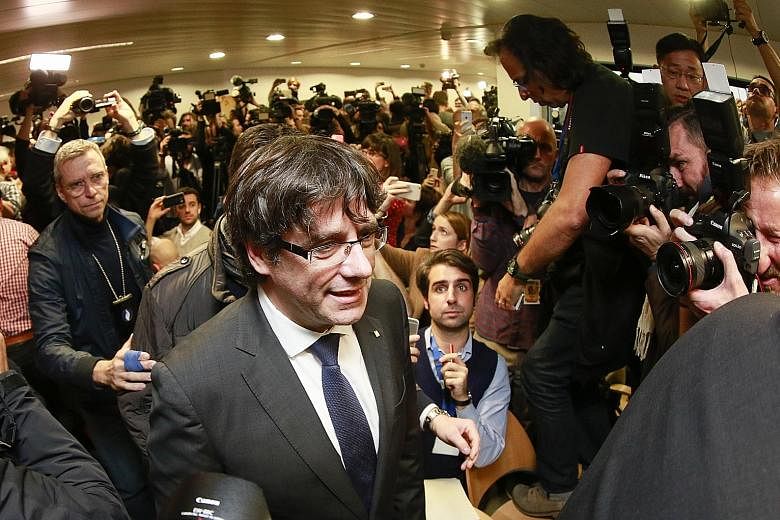 Dismissed Catalonian regional president Carles Puigdemont arriving at the Press Club in Brussels yesterday. He is in Belgium in an effort to evade arrest on charges of sedition filed against him back home in Spain.