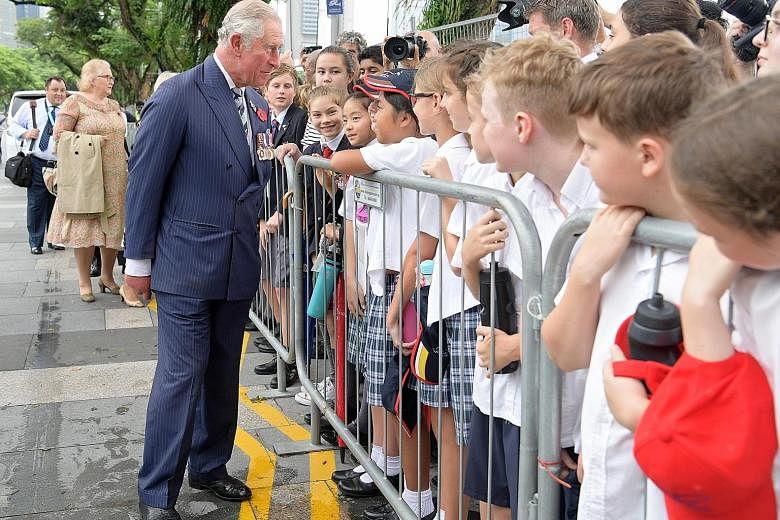 Prince Charles meeting schoolchildren and other members of the public yesterday at the Cenotaph, where he laid a wreath in memory of those who died fighting in the two world wars. The Prince and his wife Camilla, who began their Commonwealth tour in 