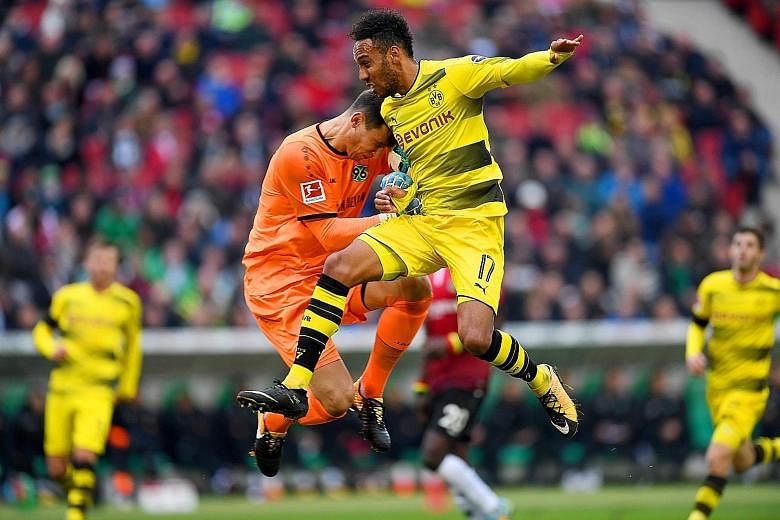 Dortmund forward Pierre-Emerick Aubameyang (right) and Hannover goalkeeper Philipp Tschauner during the 4-2 defeat that cost Dortmund their place atop the Bundesliga table. Aubameyang, the Bundesliga's top scorer last season, has not scored a goal in