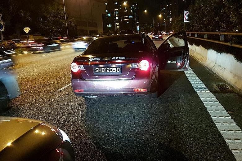 The cabby (above) taking photos of his vehicle during the incident. Mr Chia Hock Herng, the Audi driver accused of rear-ending the taxi, said the cabby got out of his vehicle and appeared to want to help, but later claimed his taxi was hit.