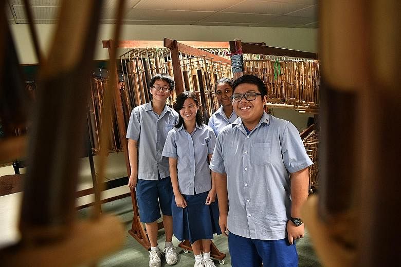 (From left) Fun Wei Yang, Tan Yu Xuan, Samia Afrin and Al Ezra Mohamed Al Johan are part of Ping Yi Secondary School's angklung ensemble, which plays Malay folk tunes as well as Chinese songs.