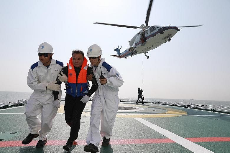 Tuesday's maritime rescue exercise simulated a collision between a Chinese passenger ship and a Cambodian cargo vessel off the coast of Guangdong province in south China.