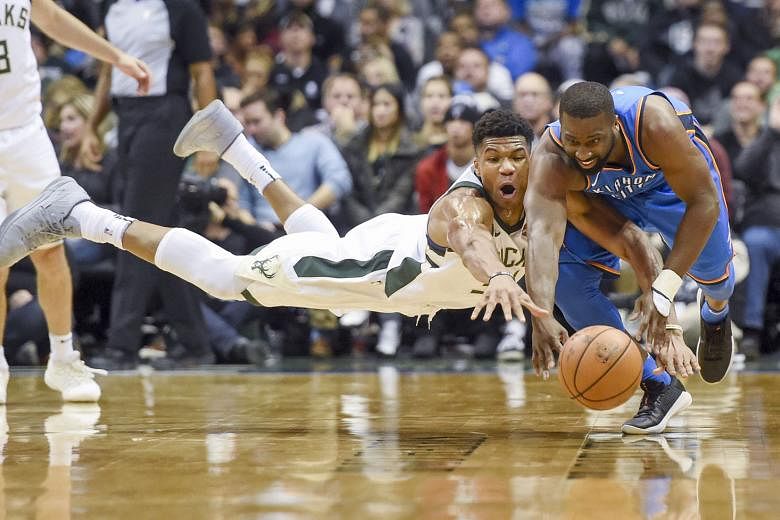 Bucks forward Giannis Antetokounmpo (left) and Thunder guard Raymond Felton battling for a loose ball. While Antetokounmpo outscored MVP Russell Westbrook, his team lost 91-110 as the visitors' defence proved too good.