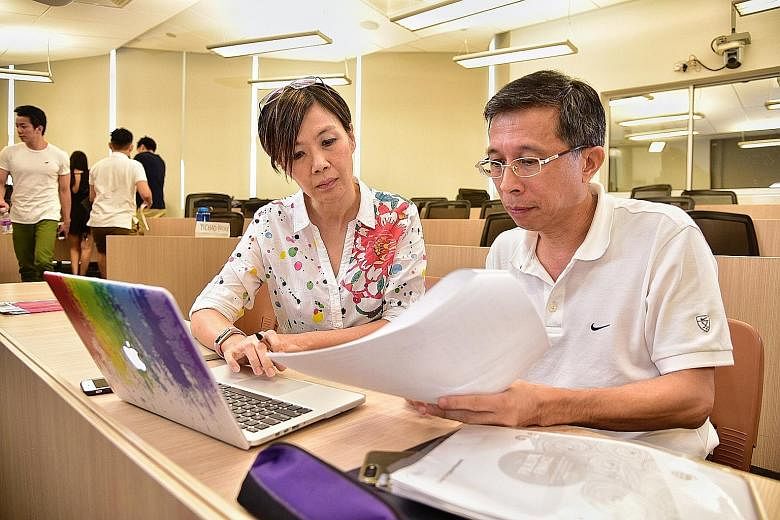 NUS alumni Genevieve Yeep, 47, and Lim Swee Hock, 54, are taking a business school module in personal finance and private wealth management at the university.