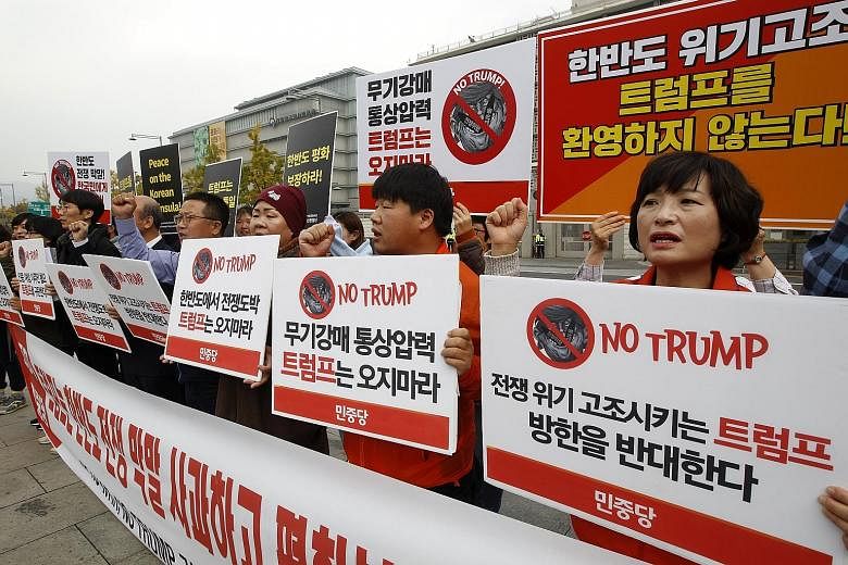 Demonstrators protesting against US President Donald Trump's visit to South Korea. China's move to settle the dispute with South Korea could scramble Mr Trump's calculations about how to deal with allies and North Korea.