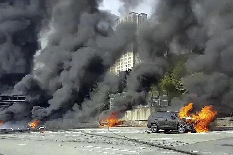 A motorway in Changwon, South Korea, was engulfed in smoke and flames following the crash and explosion of an oil tanker yesterday. The 2.5-tonne truck, which was carrying 30 drums of lubricant, had hit the median strip and overturned before catching