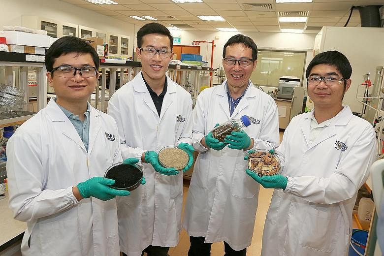 From left: Dr You Siming, 31, (holding biochar) Mr Ng Wei Cheng, 27, (holding soil sample) Professor Wang Chi-Hwa, 52, (holding horse manure with wood bedding) and Mr Shen Ye, 25 (holding wood chips) from the National University of Singapore's depart