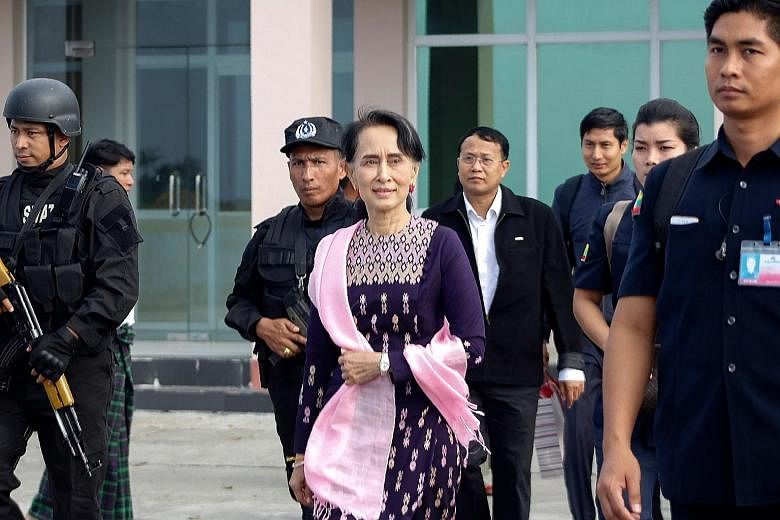 Ms Aung San Suu Kyi arriving at Sittwe airport for an unannounced visit to Rakhine state yesterday. She met Muslim religious leaders in the town of Maungdaw, one of the districts worst hit by the violence.