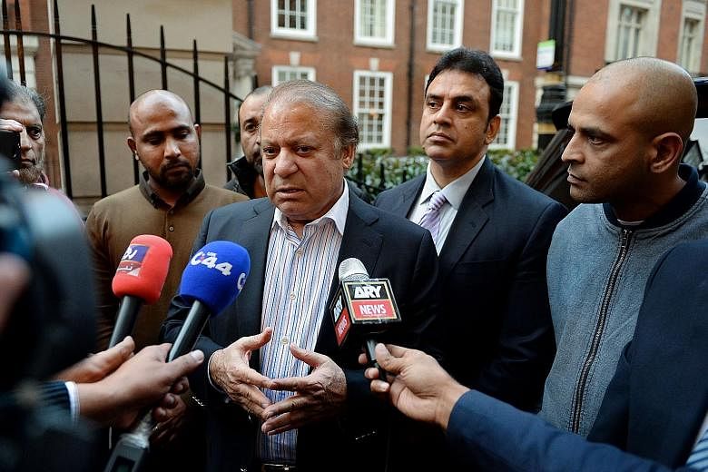 Nawaz Sharif (centre) talking to reporters on Wednesday in London, where he had gone for his wife's cancer treatment. The case against him, linked to properties his family owns in the city, could see him jailed.
