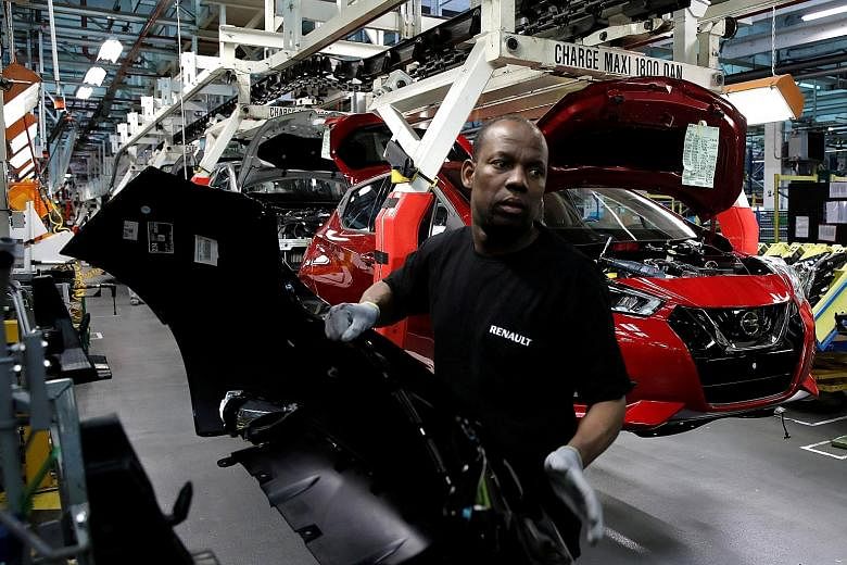 The assembly line of the Nissan Micra at the Renault car factory in Flins, near Paris, France. Renault acquired 1.4 million shares as part of the transaction and plans to offer them to employees, the company said yesterday.