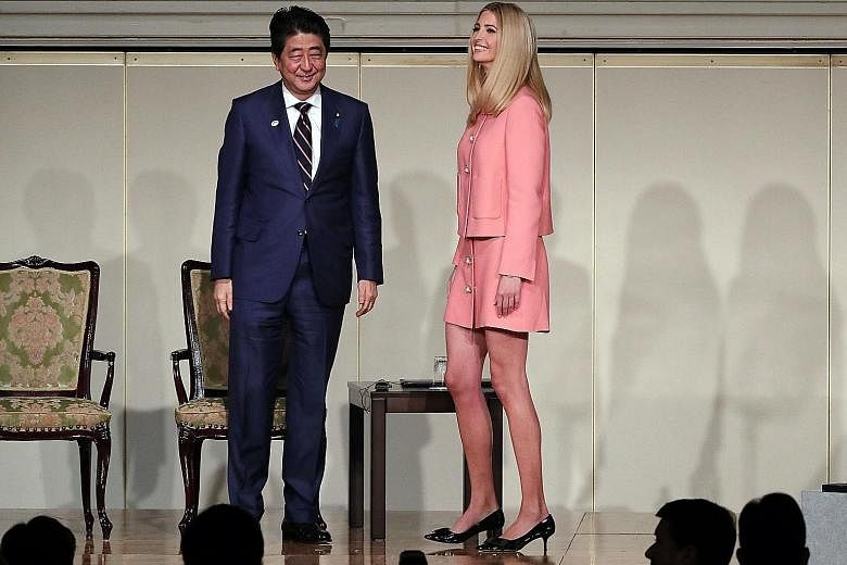 Japan's Prime Minister Shinzo Abe and Ms Ivanka Trump at the World Assembly for Women in Tokyo yesterday. Ms Trump is a supporter of the Women's Entrepreneur Finance Initiative.