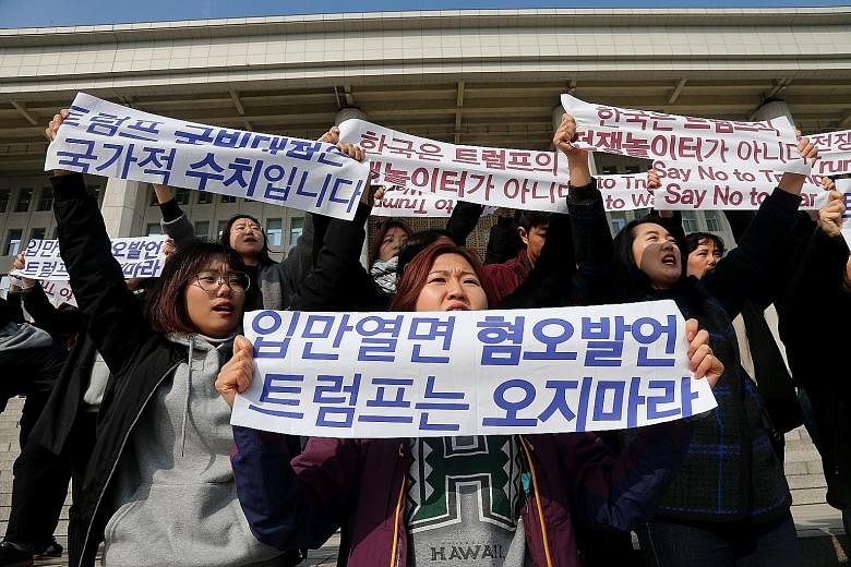 Demonstrators at a rally in Seoul yesterday to protest against US President Donald Trump's upcoming visit to South Korea.