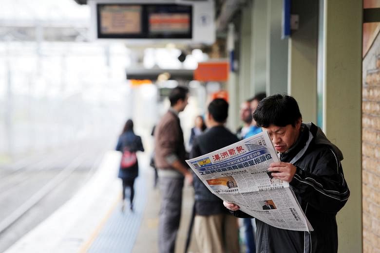 A man reading a Chinese language newspaper at a train station in Cabramatta, south-west of Sydney, Australia. Professor Feng Chongyi of the University of Technology Sydney says the influence exerted by Beijing over Chinese associations in Australia h