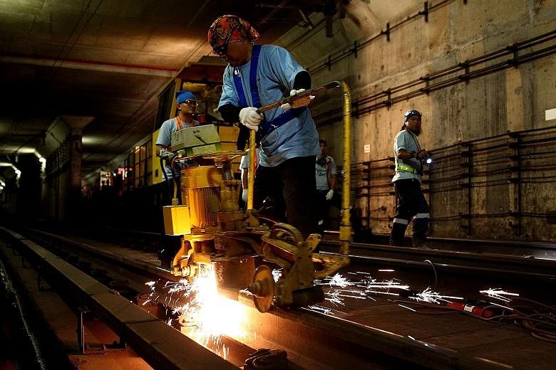Workers doing maintenance work on a rail track. Lapses happen in life - but it is quite another thing if workers wilfully breach standard operating procedures, as is suspected of the team in charge of maintaining the flood prevention system at Bishan