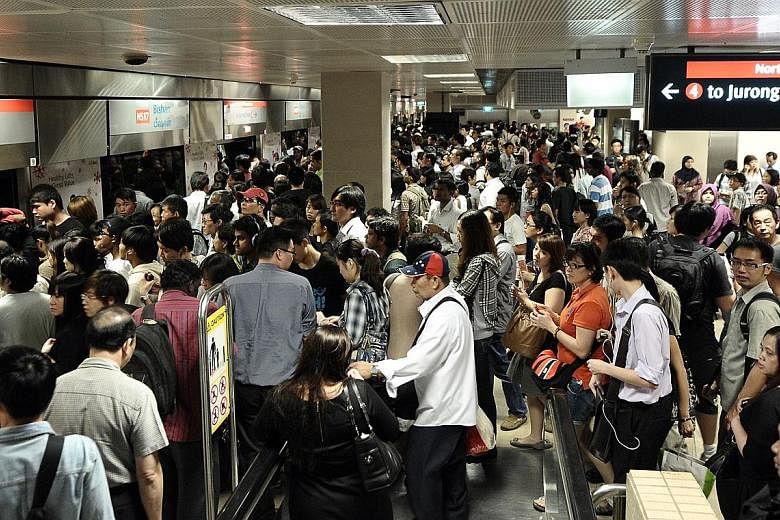 Left: Commuters at Bishan MRT station waiting for trains on Dec 15, 2011, after a massive breakdown of services on the North-South Line. Above: Last month's heavy flooding in MRT tunnels had emergency responders from the Singapore Civil Defence Force