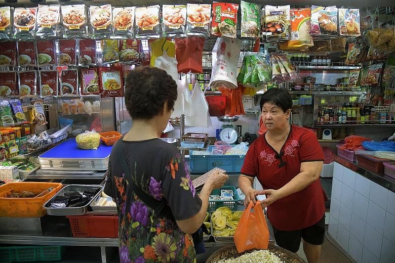 Madam Tay Geok Hua attending to a customer. She has run the stall with her husband for about 40 years and plans to retire in a couple of years now that her children have jobs of their own.