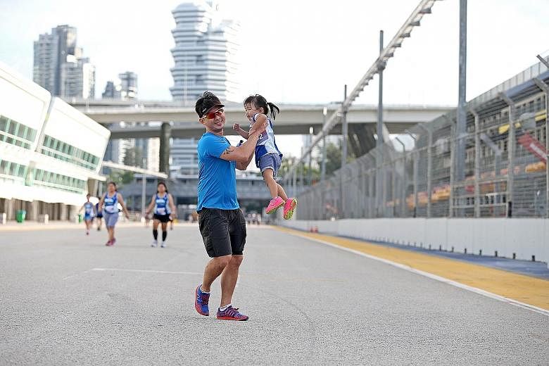 A father and his daughter taking part in the Straits Times Run In The City in July this year. Researchers found that support from family members and gamification can motivate people to exercise more.