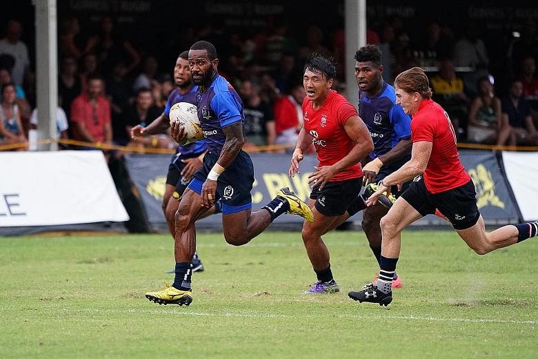 Daveta's Lemeki Tulele runs with the ball against the Hong Kong Dragons during their Singapore Cricket Club Rugby Sevens pool match yesterday.
