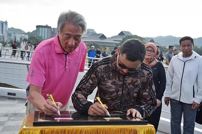 DPM Teo Chee Hean and Brunei Crown Prince Haji Al-Muhtadee Billah signing a plaque to commemorate the 5th Young Leaders' Programme at Golden Jubilee Park yesterday.