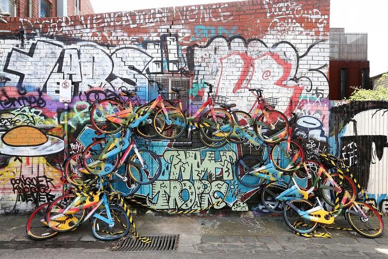 A rainbow-shaped art installation in inner-city Melbourne, made from about a dozen shared bikes. In Australia, shared bikes have ended up in trees, on top of portable toilets and in waterways.
