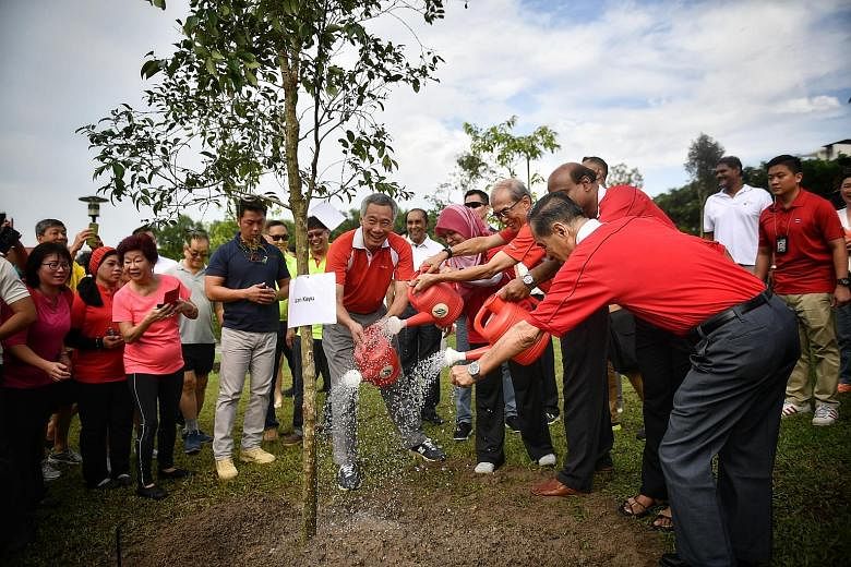 Prime Minister Lee Hsien Loong and advisers to Ang Mo Kio GRC and Sengkang West planted a Cratoxylum maingayi at Luxus Hills Park yesterday morning. The tree was one of nine planted by MPs and some 300 residents at the annual tree-planting event in A