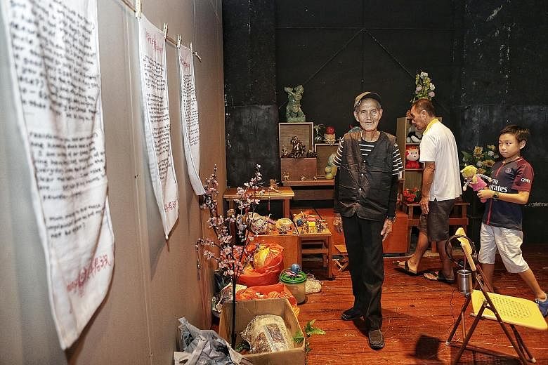 Mr Or Beng Kooi will rebuild his toy tower at The Substation with salvaged items from his original installation, as well as contributions from the public. With him are his grandson Javia Or and neighbour Wee Lai Huat. The toy tower at Block 108, Yish