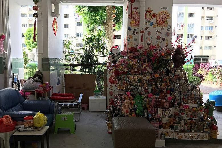 Mr Or Beng Kooi will rebuild his toy tower at The Substation with salvaged items from his original installation, as well as contributions from the public. With him are his grandson Javia Or and neighbour Wee Lai Huat. The toy tower at Block 108, Yish