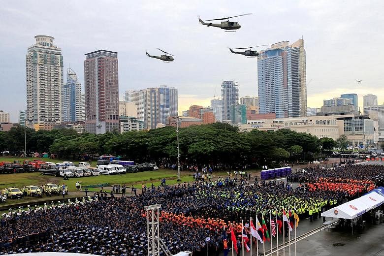 Philippine soldiers and police preparing for deployment as military helicopters flew overhead during a send-off ceremony in Manila on Sunday for the security forces for this week's Asean Summit. President Rodrigo Duterte will preside over the Asean S