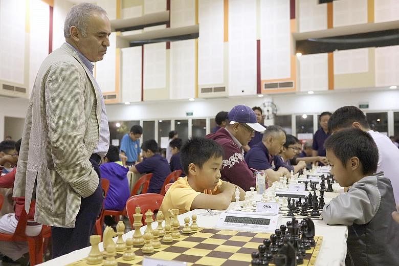 Former world chess champion Garry Kasparov observing games at the Punggol 21 Community Club. He said chess players' potential loss of energy is the mental equivalent of athletes' torn ligaments.
