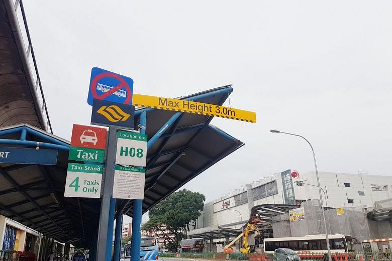 Left: Areas marked out for taxis at the taxi stand opposite VivoCity. Above: A height limit sign in bright yellow at the taxi stand outside Yishun MRT station.