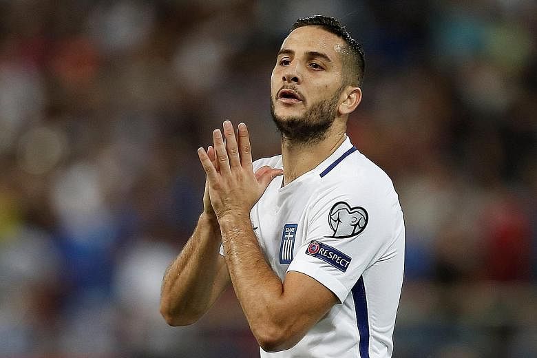 Greece centre-back Kostas Manolas will play no part in the first leg of their World Cup play-off after being banned by Fifa for a deliberate booking.