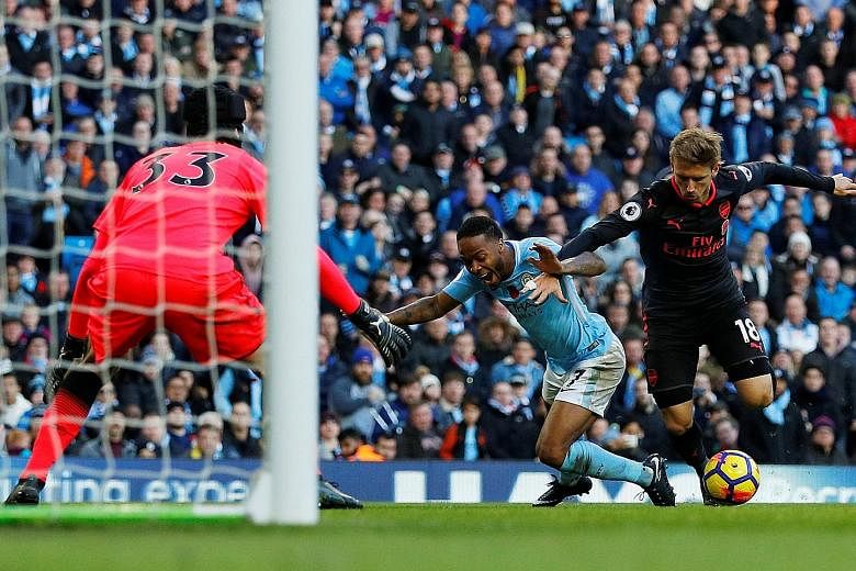 Manchester City winger Raheem Sterling going down in the box after a challenge from Arsenal defender Nacho Monreal to earn his side a penalty on Sunday. Arsenal manager Arsene Wenger will not face an FA charge despite accusing Sterling of diving.