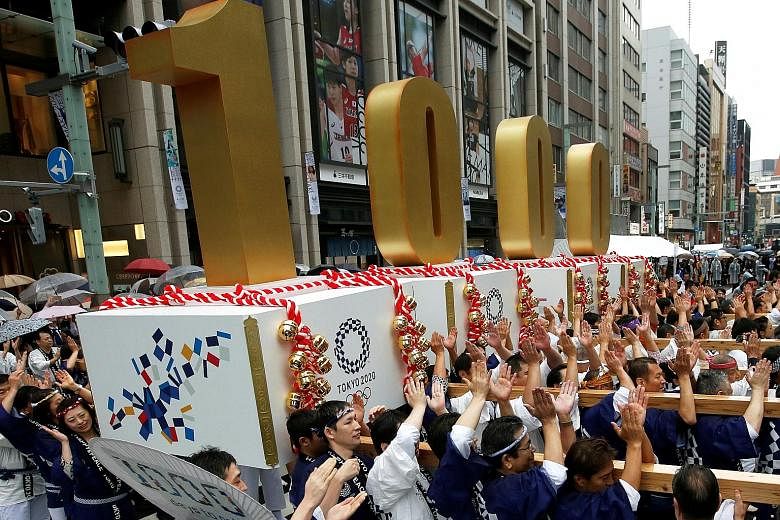 Japanese participants carrying portable floats bearing the number 1,000 at the Oct 28 countdown ceremony to mark 1,000 days until the commencement of the 2020 Olympic Games in Tokyo.