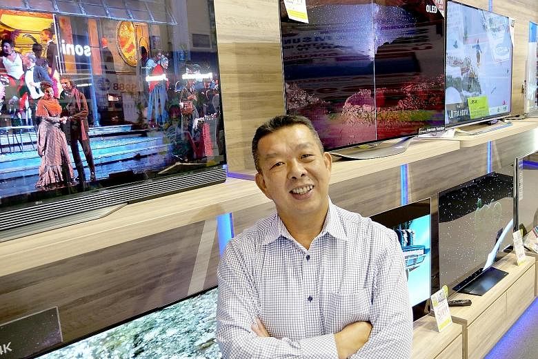 Audio House managing director Alvin Lee at the store in Bendemeer Road, which is the retailer's only outlet left. He believes the company is the first local consumer electronics retailer to go fully cashless, and said the move is expected to help it 