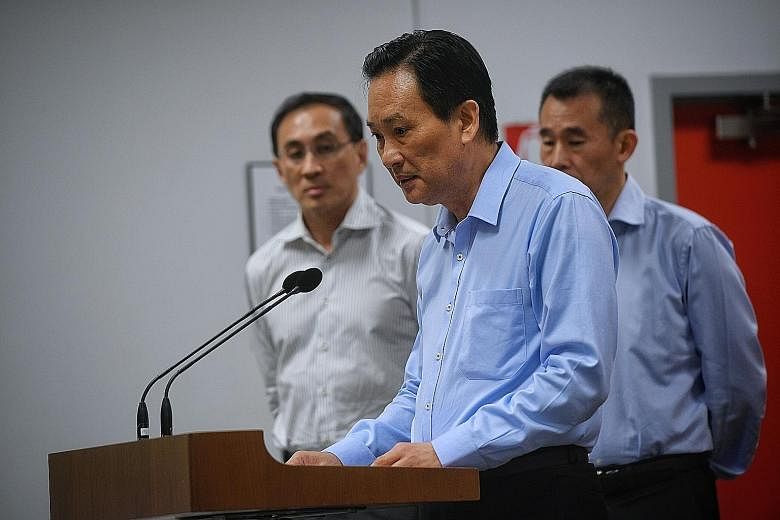 SMRT chairman Seah Moon Ming speaking at the Oct 16 media briefing on the MRT tunnel flooding incident. With him were SMRT CEO Desmond Kuek (far left) and SMRT Trains CEO Lee Ling Wee.