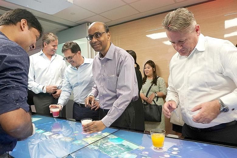 Deputy Prime Minister Tharman Shanmugaratnam at a health and digital innovation showcase in Prudential Singapore's new office at Marina One.