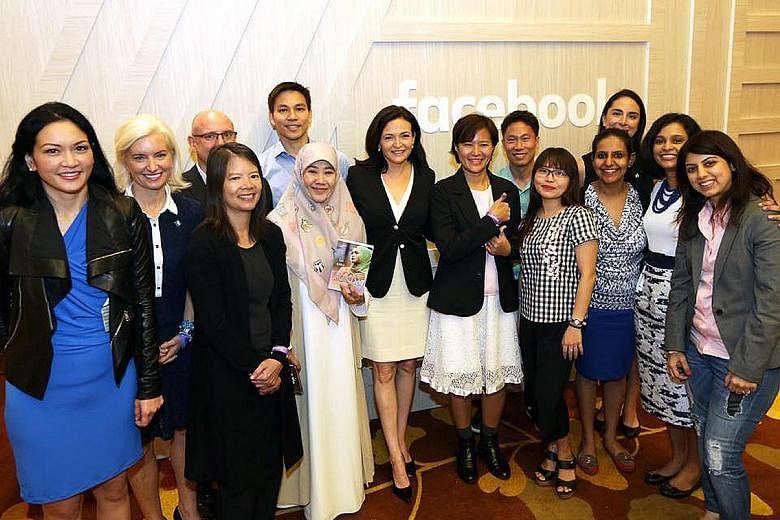 Facebook chief operating officer Sheryl Sandberg (middle) with staff and community leaders from Singapore and the region at the first Asia-Pacific Facebook Community event at Marina Bay Sands yesterday.