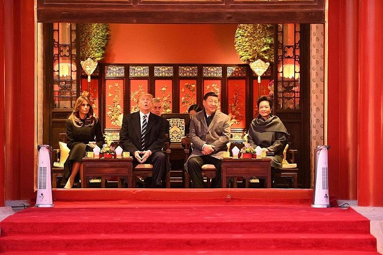 US President Donald Trump and Chinese President Xi Jinping with US First Lady Melania Trump and Mr Xi's wife Peng Liyuan during a tour of the Forbidden City in Beijing yesterday.