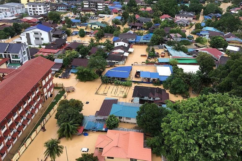 An aerial view of a flooded residential area in Georgetown, Penang, on Sunday. The floods over the weekend claimed seven lives and displaced more than 7,000 people.