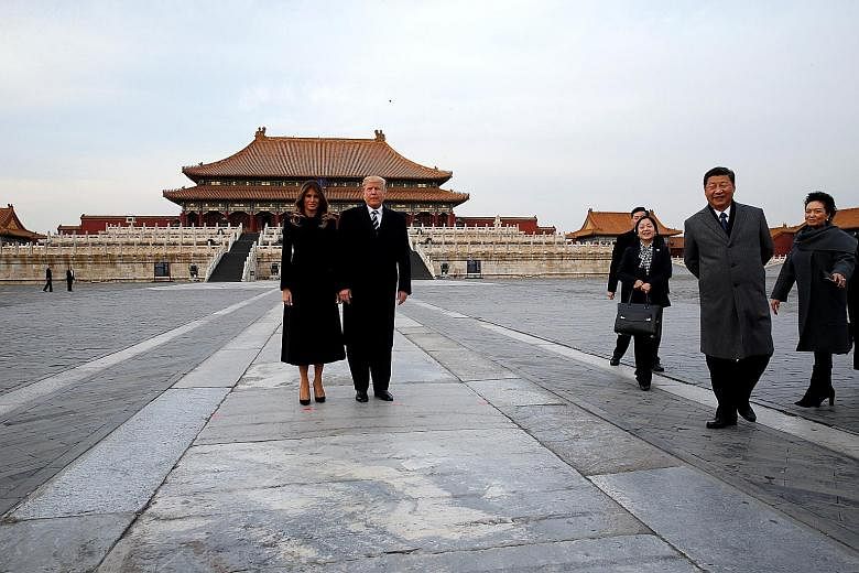 US President Donald Trump and his wife Melania posing for a photo at the Forbidden City yesterday. They were accompanied during the visit by Chinese President Xi Jinping and his wife Peng Liyuan (at far right).