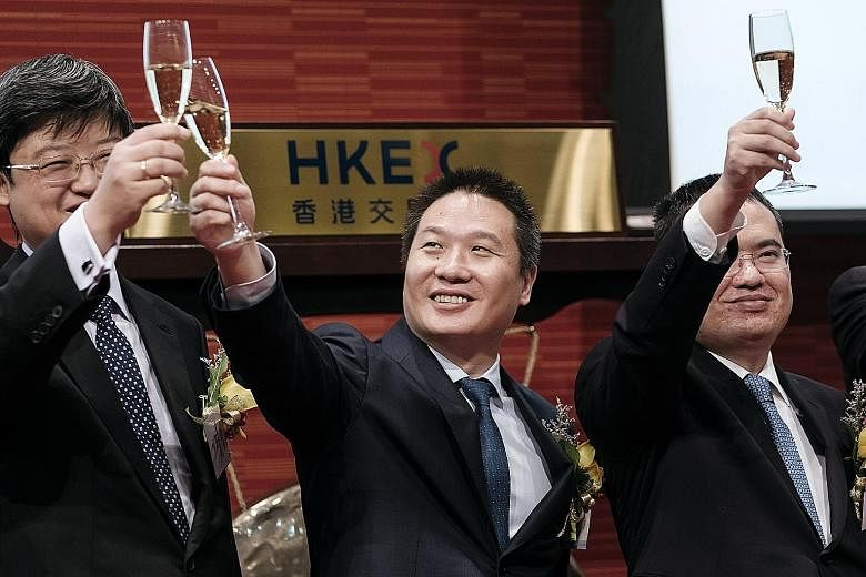 (From left) China Literature president Shang Xuesong and co-CEOs Liang Xiaodong and Wu Wenhui, at the company's listing ceremony at the Hong Kong stock exchange. Demand for the IPO was such that retail investors bid for 625 times the shares on offer.